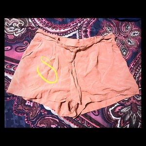 Coral pink colored shorts with tie in front.